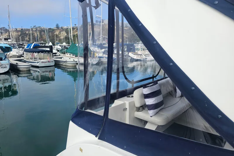 Slide: The Image of 2005 Bayliner 2855 Ciera docked in a marina with striped cushions. - 4