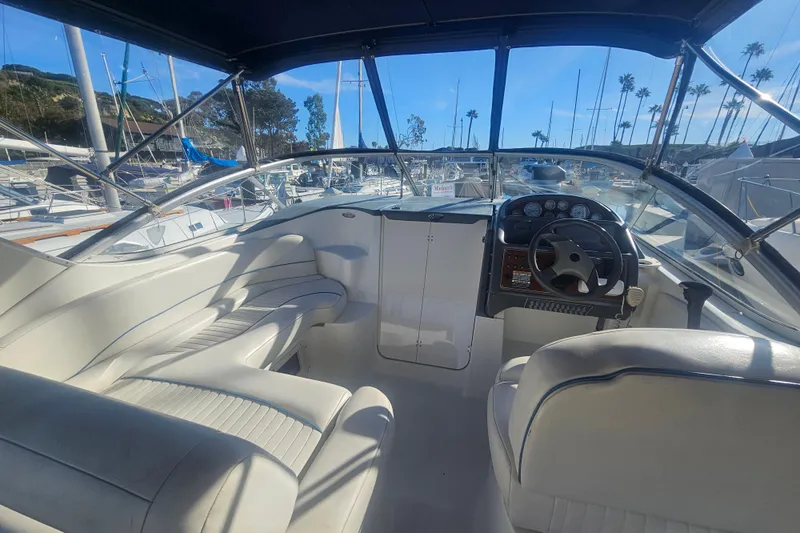 Slide: The Image of 2005 Bayliner 2855 Ciera boat interior with steering wheel and seating, docked at marina. - 8