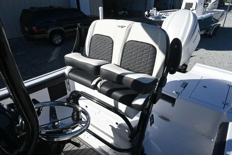 Slide: The Image of 2026 Tidewater 2300 Carolina Bay boat interior with dual seats and steering wheel. - 10