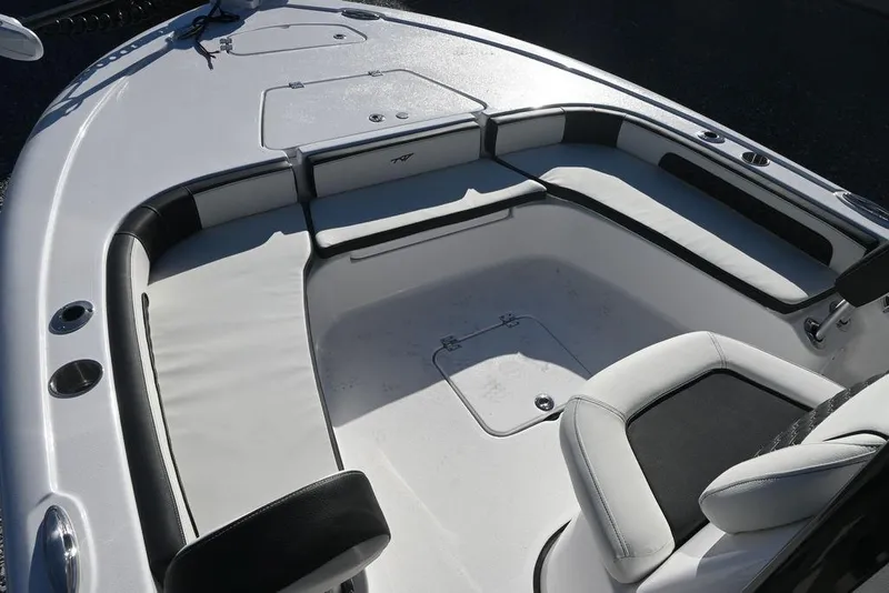 Slide: The Image of 2026 Tidewater 2300 Carolina Bay boat interior with cushioned seating and storage compartments. - 22