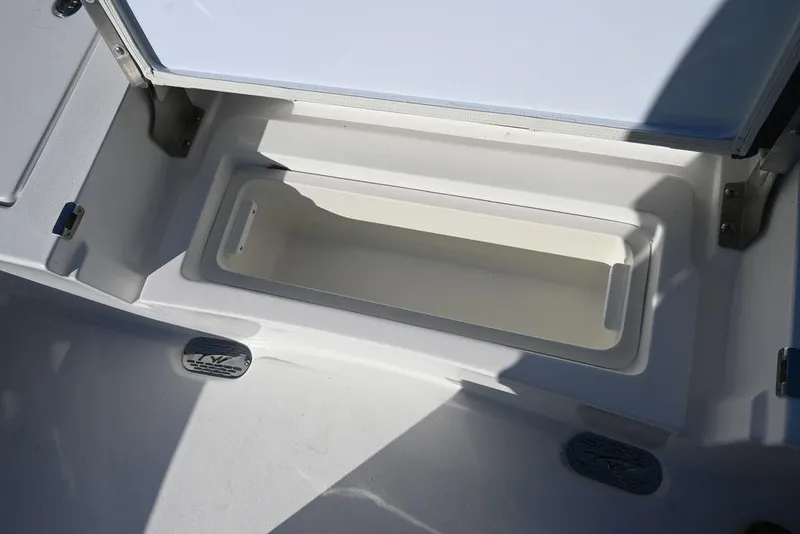 Slide: The Image of 2026 Tidewater 2300 Carolina Bay storage compartment, open and empty, with white interior. - 23