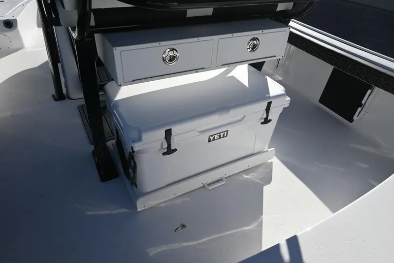 Slide: The Image of 2026 Tidewater 2300 Carolina Bay boat interior with Yeti cooler and storage drawers. - 26
