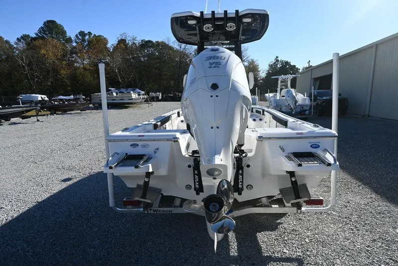 Slide: The Image of 2026 Tidewater 2300 Carolina Bay boat with powerful outboard motor, parked outdoors. - 8
