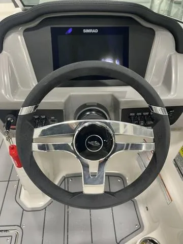 Slide: The Image of Steering wheel and dashboard of 2025 Chaparral 23 SSi boat with Simrad display. - 12