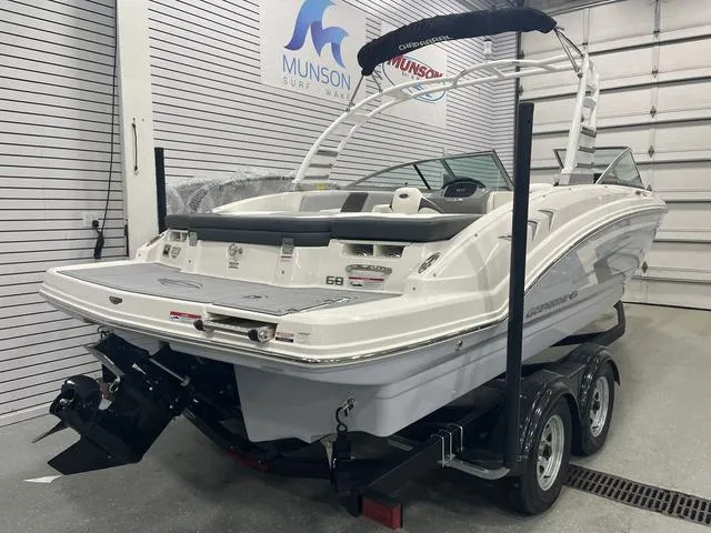 Slide: The Image of 2025 Chaparral 23 SSi boat on trailer in showroom, rear view. - 4