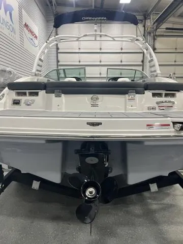 Slide: The Image of 2025 Chaparral 23 SSi boat in showroom, rear view with propeller visible. - 6