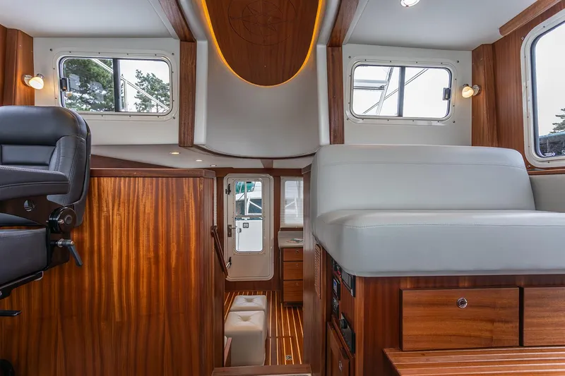 Slide: The Image of Interior of 2026 American Tug 362, featuring wood paneling and seating. - 10