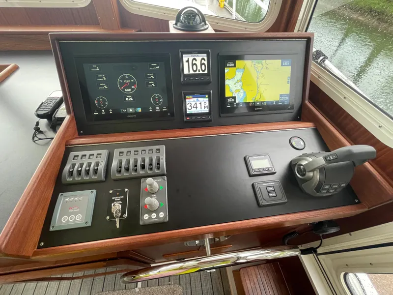 Slide: The Image of American Tug 362 2025 model helm station with navigation and control panels. - 14