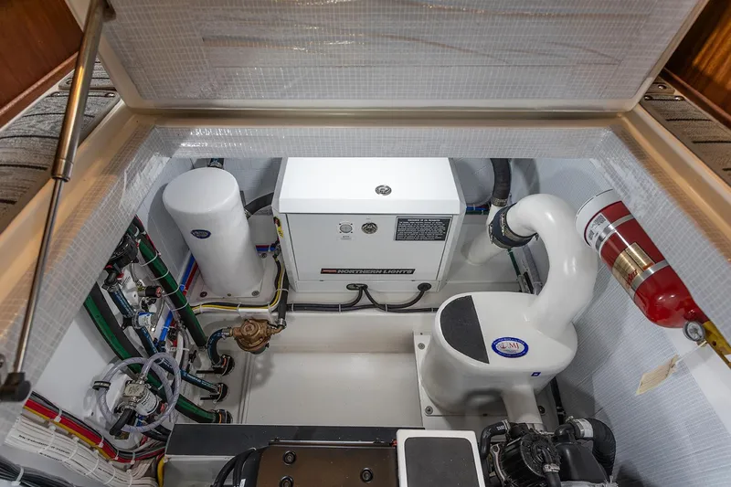 Slide: The Image of Engine compartment of 2026 American Tug 362, featuring mechanical components and fire extinguisher. - 16