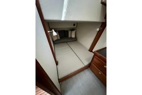 Slide: The Image of 2026 American Tug 362 cabin interior with cozy bed and wooden accents. - 25