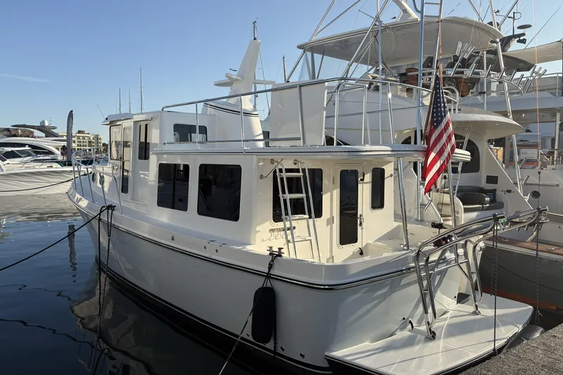 Slide: The Image of 2026 American Tug 362 docked at marina with American flag displayed. - 6