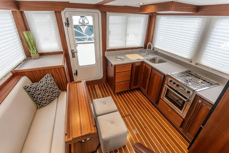 Slide: The Image of Interior of 2026 American Tug 362 with modern kitchen and seating area. - 8