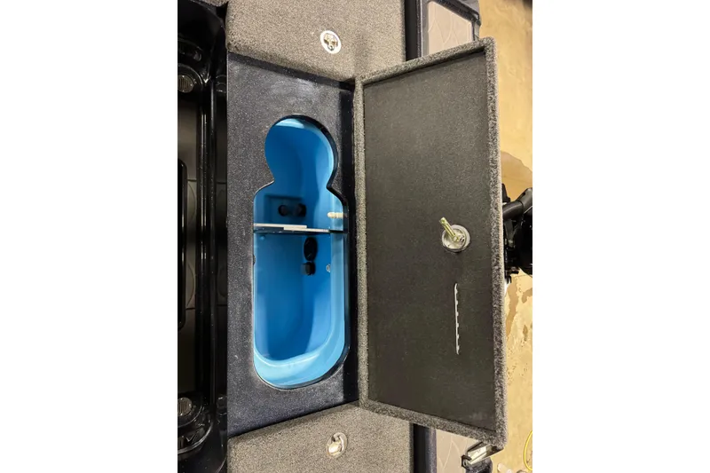 Slide: The Image of Open storage compartment in 2026 Nitro ZV20 Pro boat, featuring a blue interior. - 24
