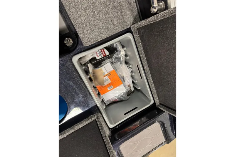 Slide: The Image of Storage compartment of 2026 Nitro ZV20 Pro boat with various items inside. - 25