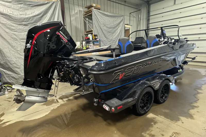Slide: The Image of 2026 Nitro ZV20 Pro boat with powerful outboard motor in a garage setting. - 3
