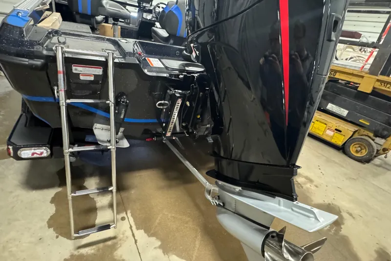 Slide: The Image of 2026 Nitro ZV20 Pro boat with ladder and powerful outboard motor in a garage setting. - 5