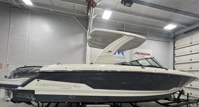 Slide: The Image of 2025 Chaparral 30 Surf boat in showroom, side view. - 13