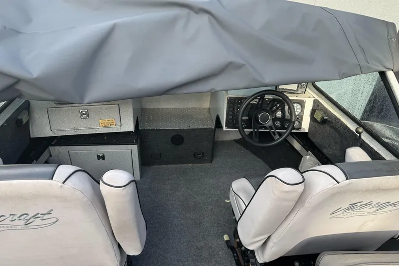 Slide: The Image of Interior of a 1994 Jetcraft Yukon boat with covered dashboard and seating. - 13