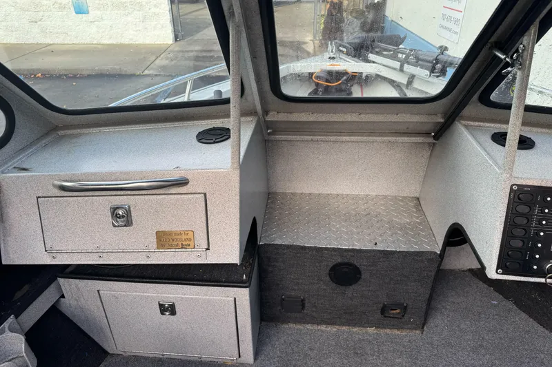 Slide: The Image of Interior of a 1994 Jetcraft Yukon boat with storage compartments and control panel. - 14