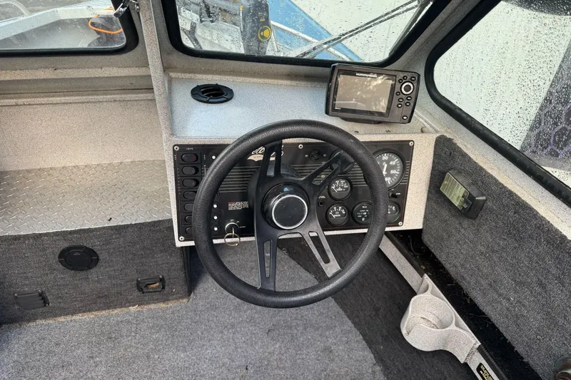 Slide: The Image of Interior of a 1994 Jetcraft Yukon boat showing steering wheel and control panel. - 16