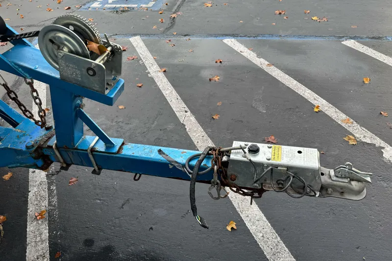 Slide: The Image of Trailer hitch and winch on a 1994 Jetcraft Yukon in a parking lot. - 2