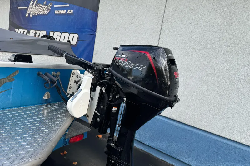 Slide: The Image of 1994 Jetcraft Yukon boat with Mercury Pro Kicker outboard motor, displayed outdoors. - 25