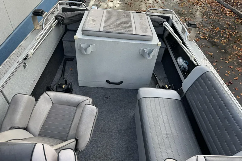 Slide: The Image of 1994 Jetcraft Yukon boat interior with gray seating and storage compartments. - 9
