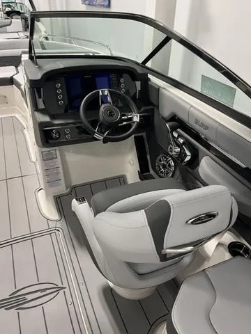 Slide: The Image of 2025 Chaparral 26 Surf boat interior with modern dashboard and steering wheel. - 8