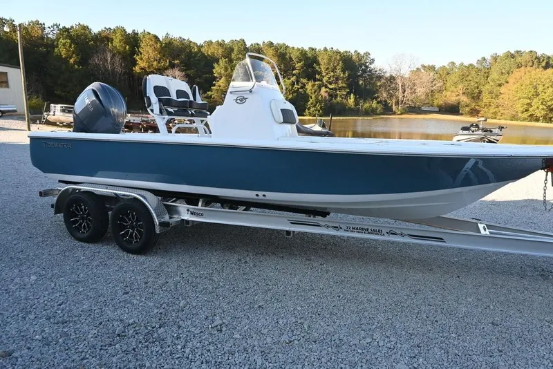 The Image of 2026 Tidewater 2110 Bay Max boat on trailer, parked near a serene lake. - 1