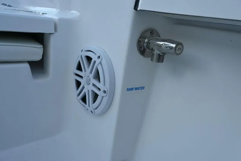 Slide: The Image of 2026 Tidewater 2110 Bay Max boat with raw water outlet and speaker detail. - 14