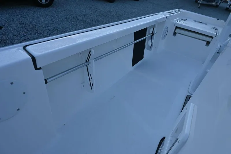 Slide: The Image of 2026 Tidewater 2110 Bay Max boat interior with sleek white design and storage features. - 16