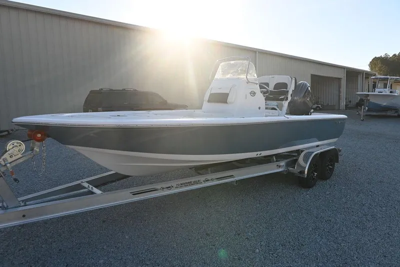 Slide: The Image of 2026 Tidewater 2110 Bay Max boat on trailer, sunlit background. - 3