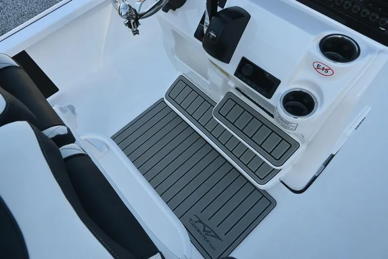 Slide: The Image of 2026 Tidewater 2110 Bay Max boat interior with steering wheel, cup holders, and non-slip flooring. - 6