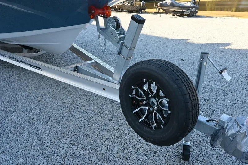 Slide: The Image of Trailer for 2026 Tidewater 2110 Bay Max boat on gravel surface. - 8