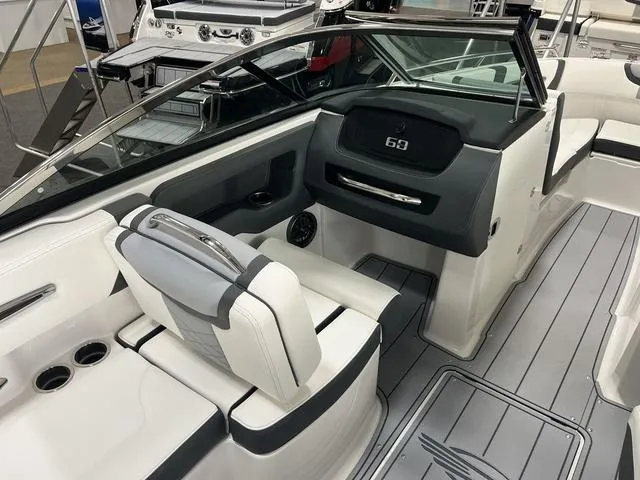 Slide: The Image of 2025 Chaparral 247 SSX boat interior with sleek seating and modern dashboard design. - 8