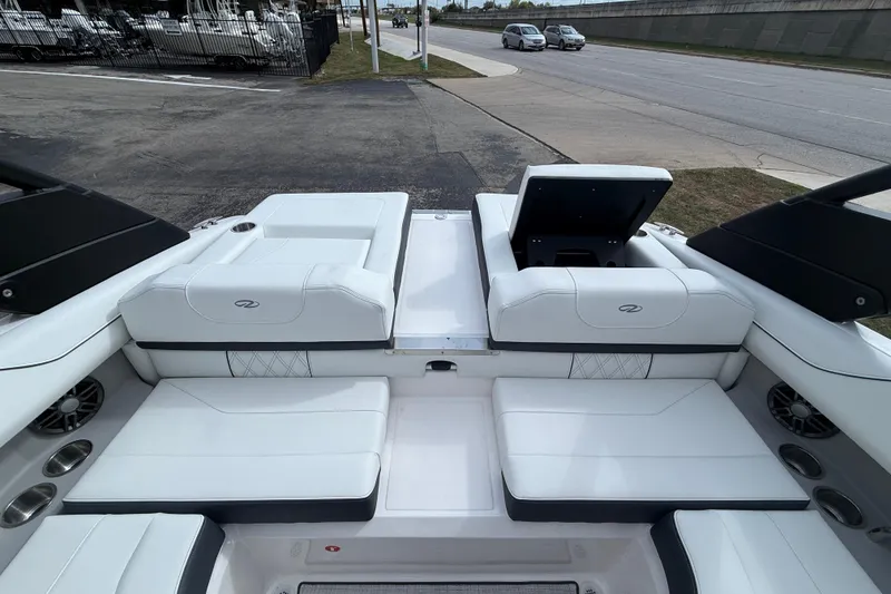 Slide: The Image of 2026 Regal LS2 boat interior with white seating and open storage compartment. - 13