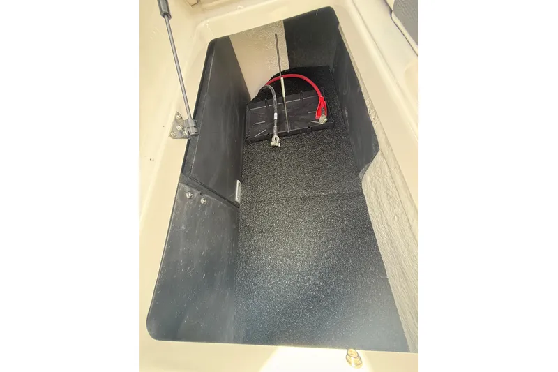 Slide: The Image of 2026 Regal LS2 boat storage compartment with battery and wiring. - 17