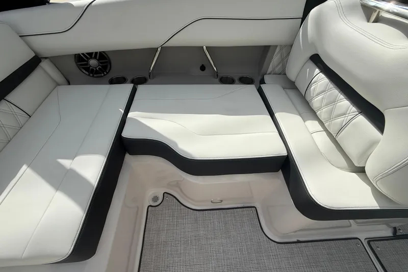 Slide: The Image of 2026 Regal LS2 boat interior with luxurious white seating and cup holders. - 19