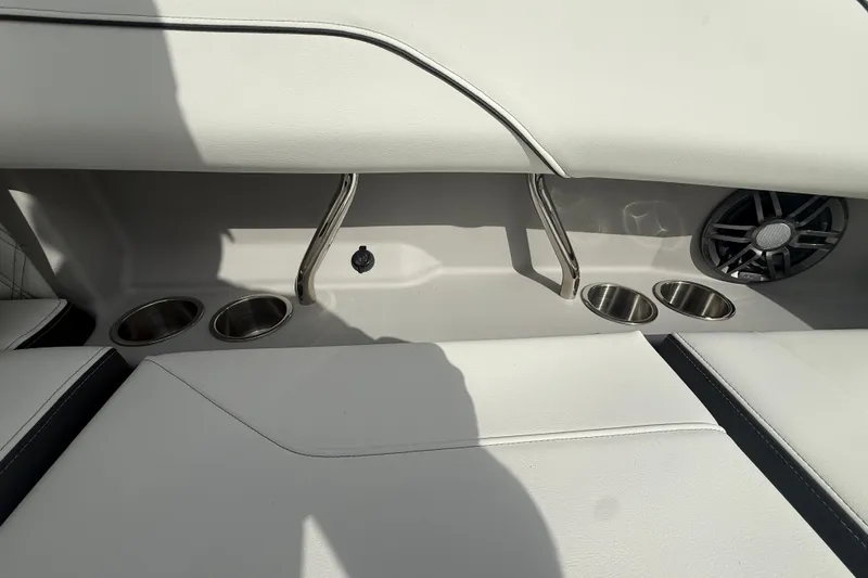 Slide: The Image of 2026 Regal LS2 boat interior with cup holders and speaker. - 23