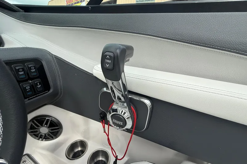 Slide: The Image of Interior of 2026 Regal LS2 boat showing control panel and trim lever. - 29