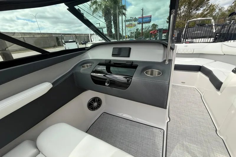Slide: The Image of 2026 Regal LS2 boat interior with modern dashboard, cup holders, and seating. - 33