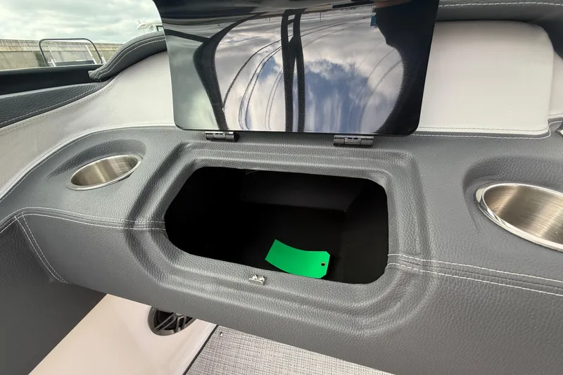 Slide: The Image of 2026 Regal LS2 boat interior with storage compartment and cup holders. - 35