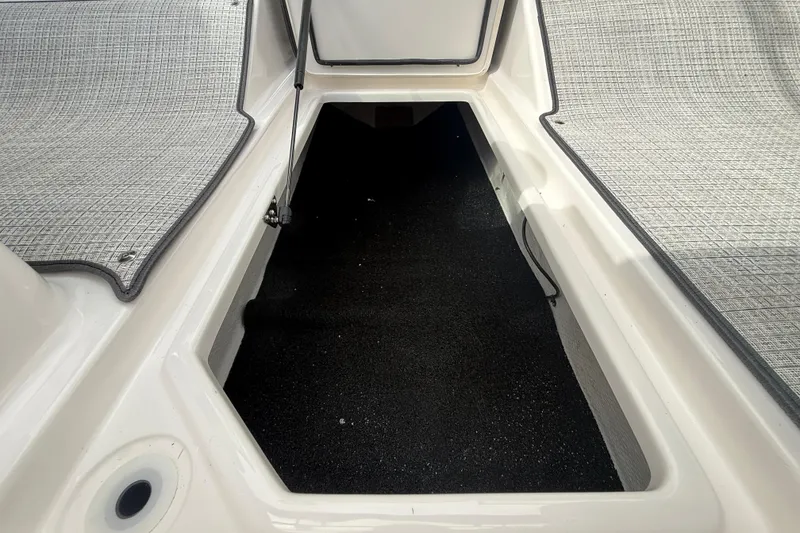 Slide: The Image of 2026 Regal LS2 boat interior storage compartment with textured flooring. - 37