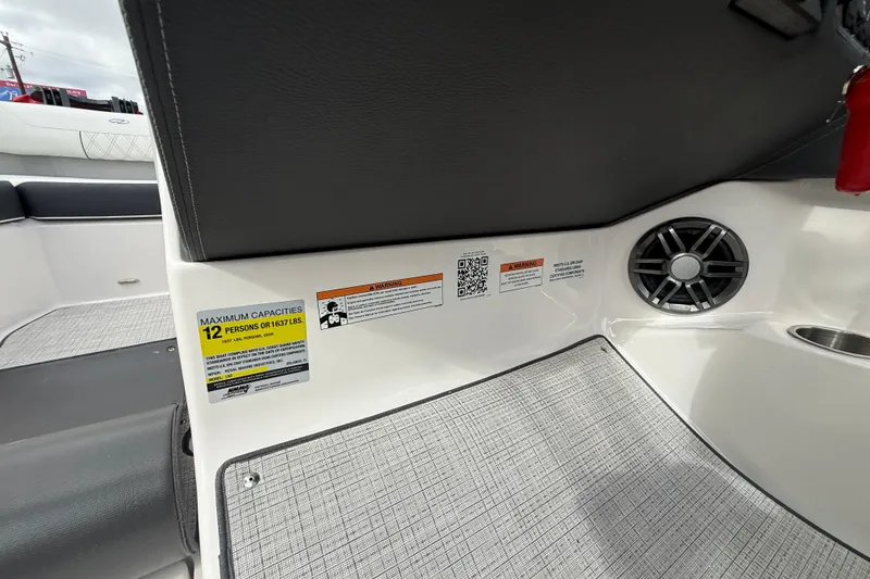 Slide: The Image of 2026 Regal LS2 boat interior with capacity label, speaker, and textured flooring. - 38