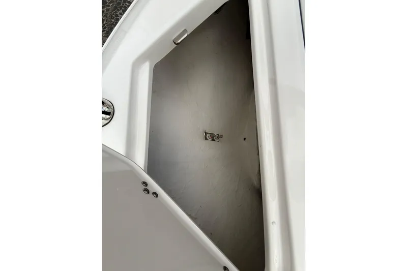 Slide: The Image of Storage compartment of 2026 Regal LS2 boat, featuring sleek white interior design. - 52
