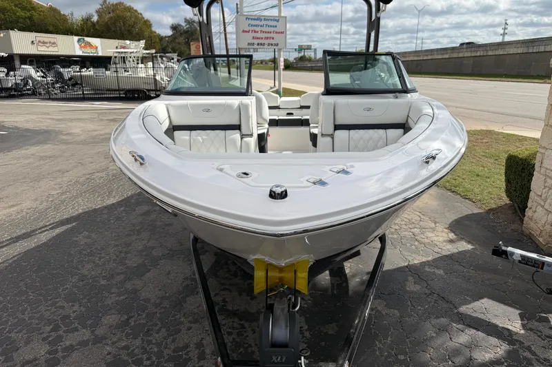 Slide: The Image of 2026 Regal LS2 boat on trailer, parked outdoors, showcasing sleek design and seating. - 7