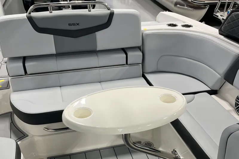 Slide: The Image of 2025 Chaparral 247 SSX boat interior with gray seating and oval table. - 4