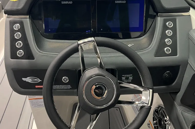 Slide: The Image of 2025 Chaparral 247 SSX boat dashboard with steering wheel and Simrad displays. - 6