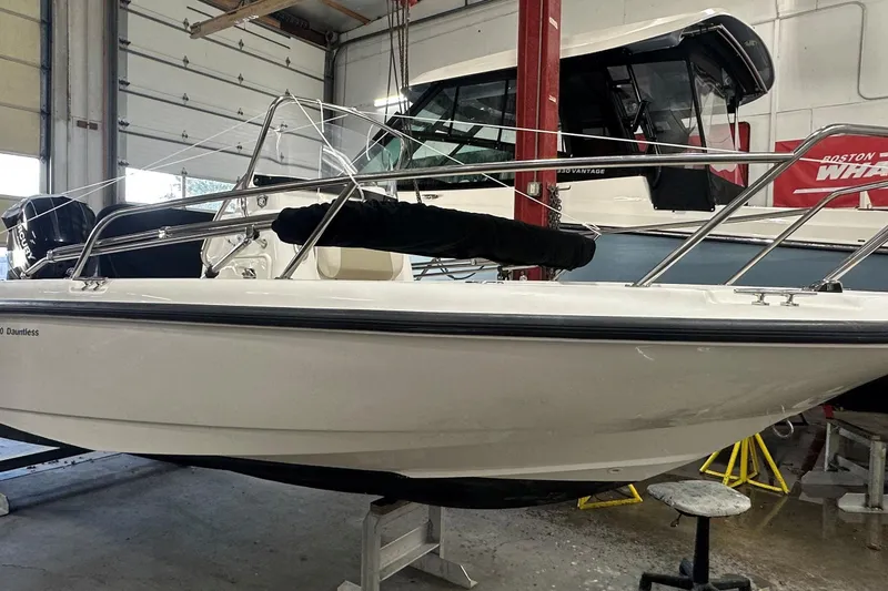 Slide: The Image of 2018 Boston Whaler 180 Dauntless boat in a garage setting. - 2
