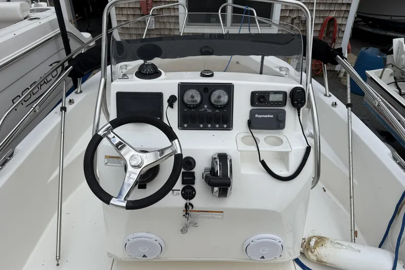 Slide: The Image of 2018 Boston Whaler 180 Dauntless boat console with steering wheel and navigation equipment. - 5
